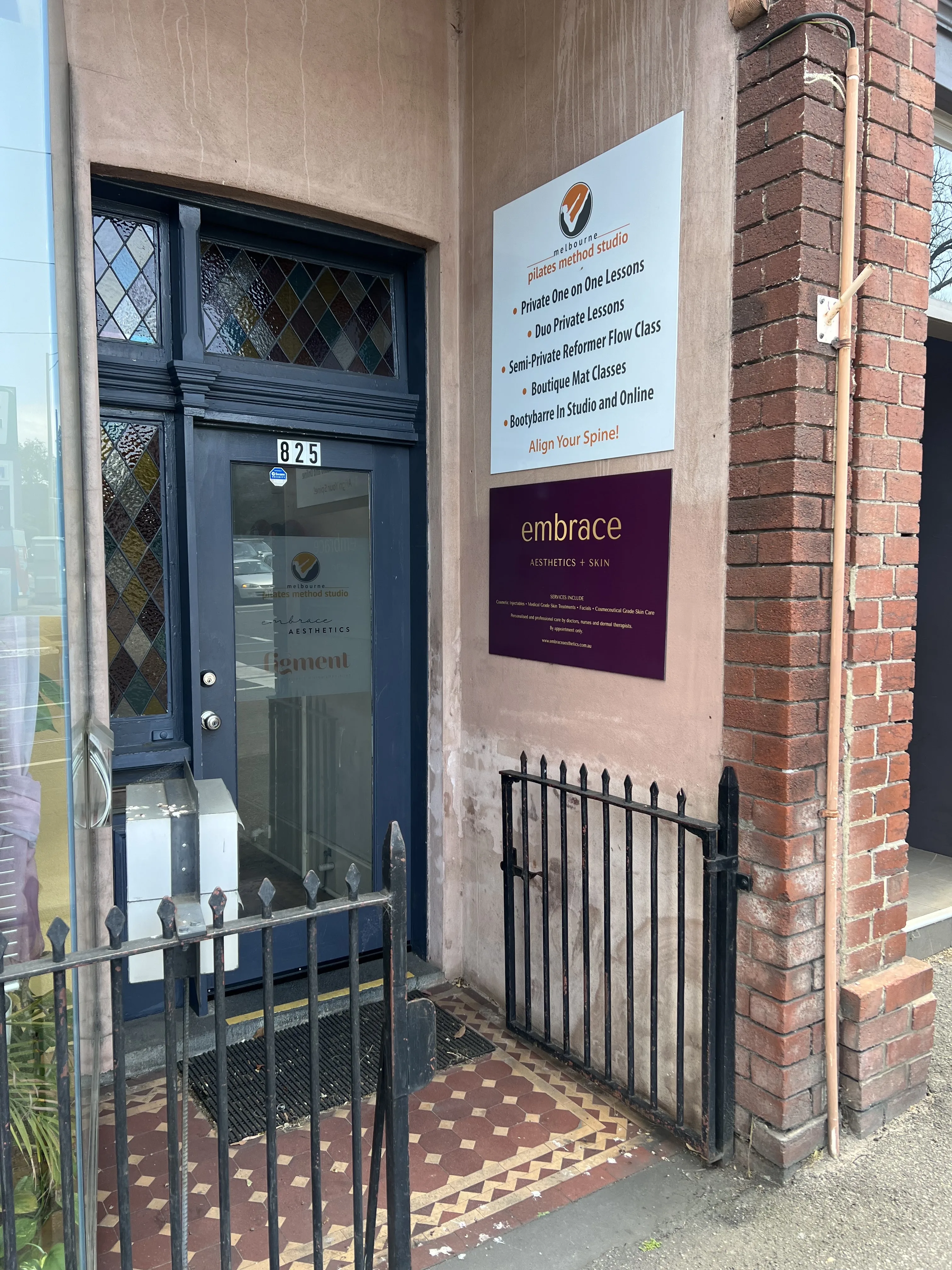 The heritage stained-glass doorway at 825 Glenferrie Rd — the entrance to Embrace Aesthetics and Skin